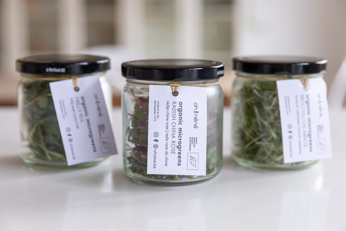 oh nènè microgreens on a glass jar with a hanging label